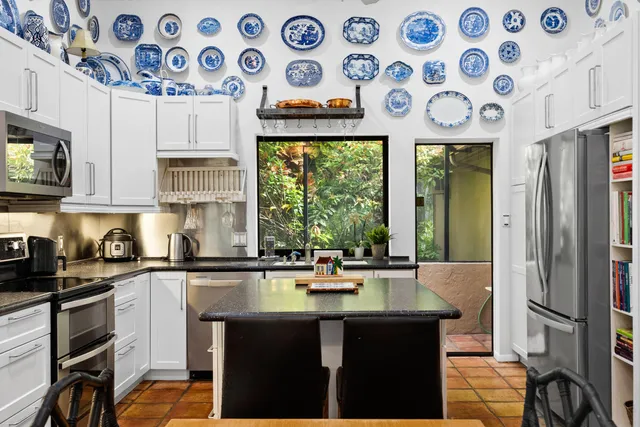 a kitchen with a sink a stove a refrigerator and cabinets