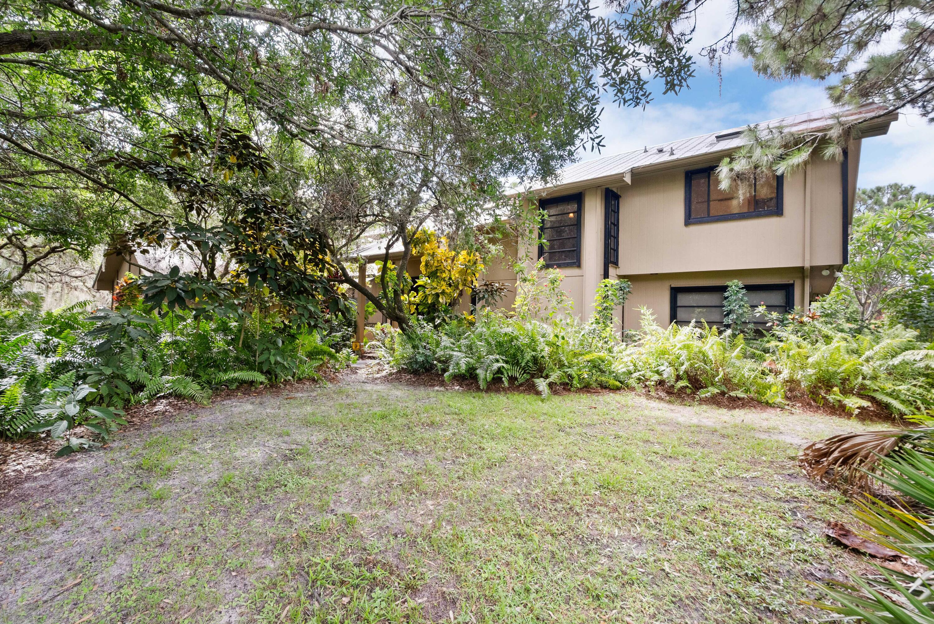 3217 Northwest Perimeter Road Palm City, FL 34990 - Photo 59 of 64 a view of a house with a yard