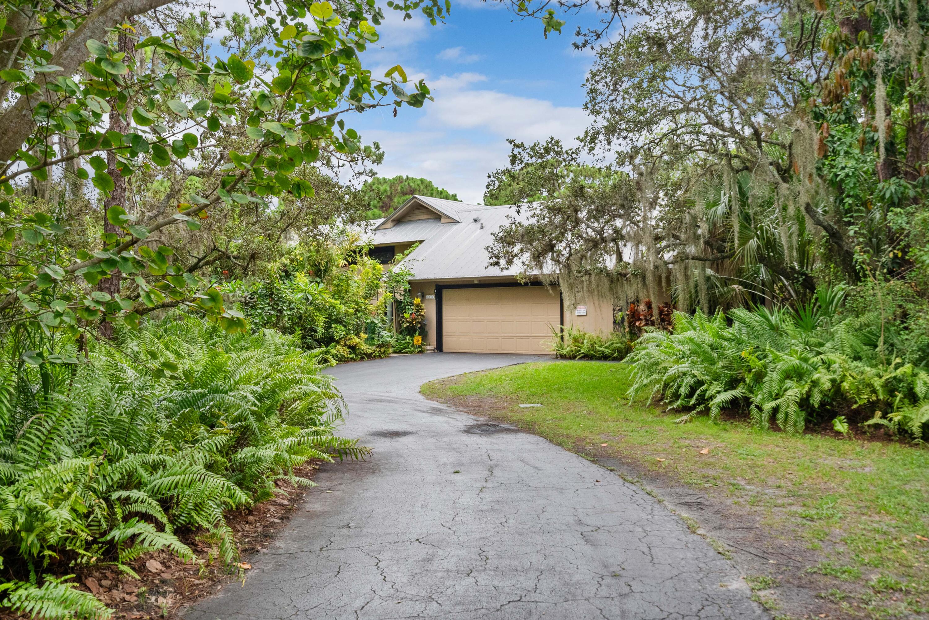 3217 Northwest Perimeter Road Palm City, FL 34990 - Photo 60 of 64 a front view of a house with garden