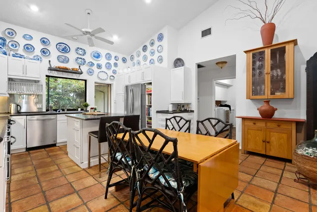 a kitchen with stainless steel appliances kitchen island granite countertop a sink and cabinets