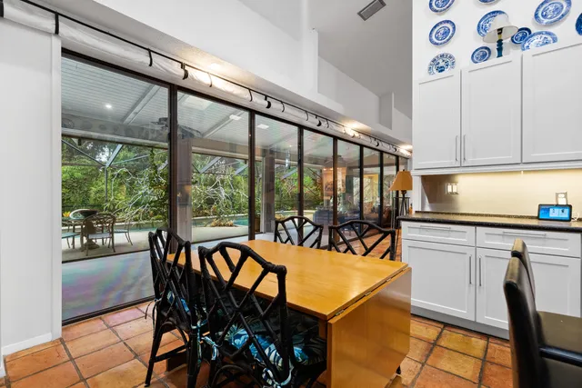 a view of a dining room with furniture a chandelier and wooden floor