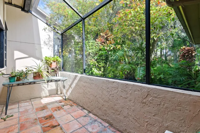 a view of a patio with a table and chairs and potted plants