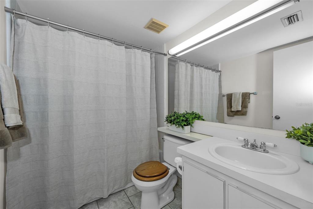 2687 Pine Ridge Way South, Unit B2 Palm Harbor, FL 34684 - Photo 27 of 68 a bathroom with a granite countertop sink and a mirror