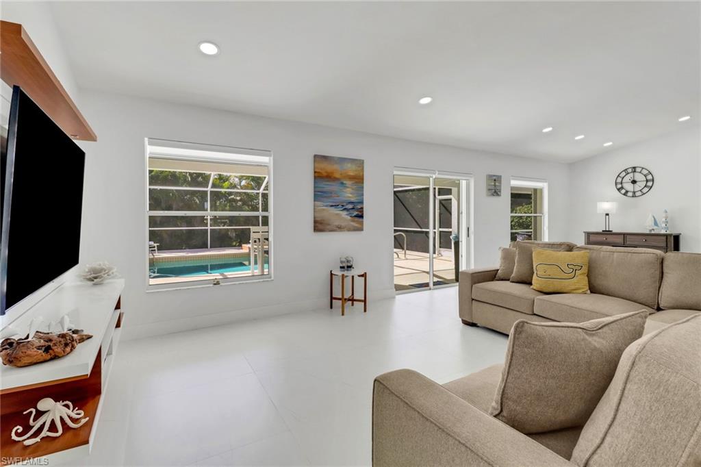 172 Plantation Circle Naples, FL 34104 - Photo 10 of 36 a living room with furniture and a flat screen tv