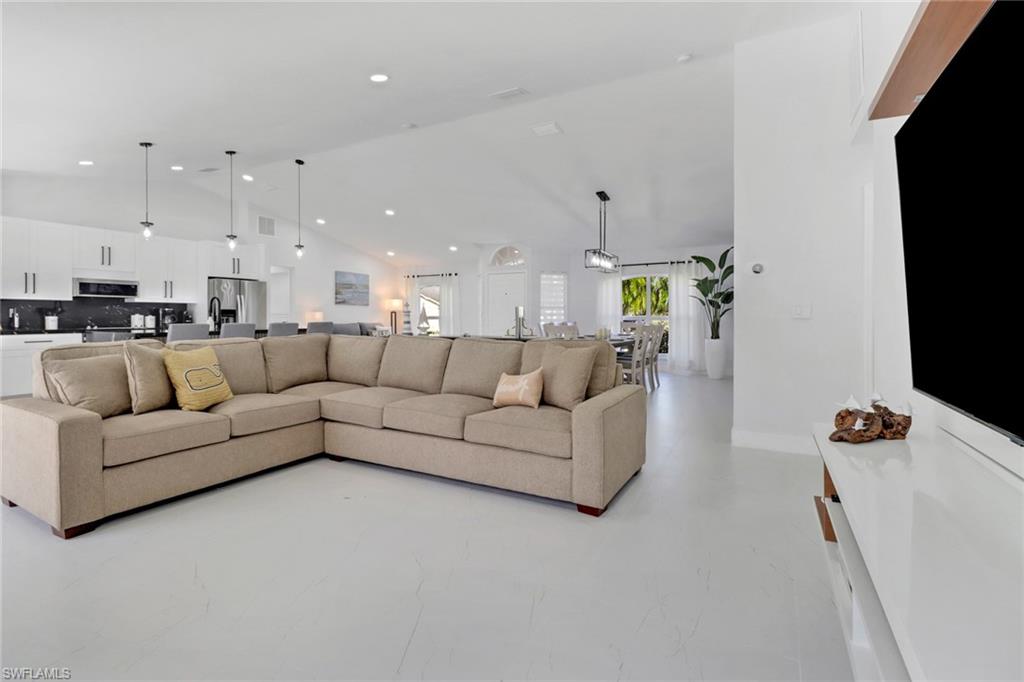 172 Plantation Circle Naples, FL 34104 - Photo 11 of 36 a living room with furniture and a flat screen tv