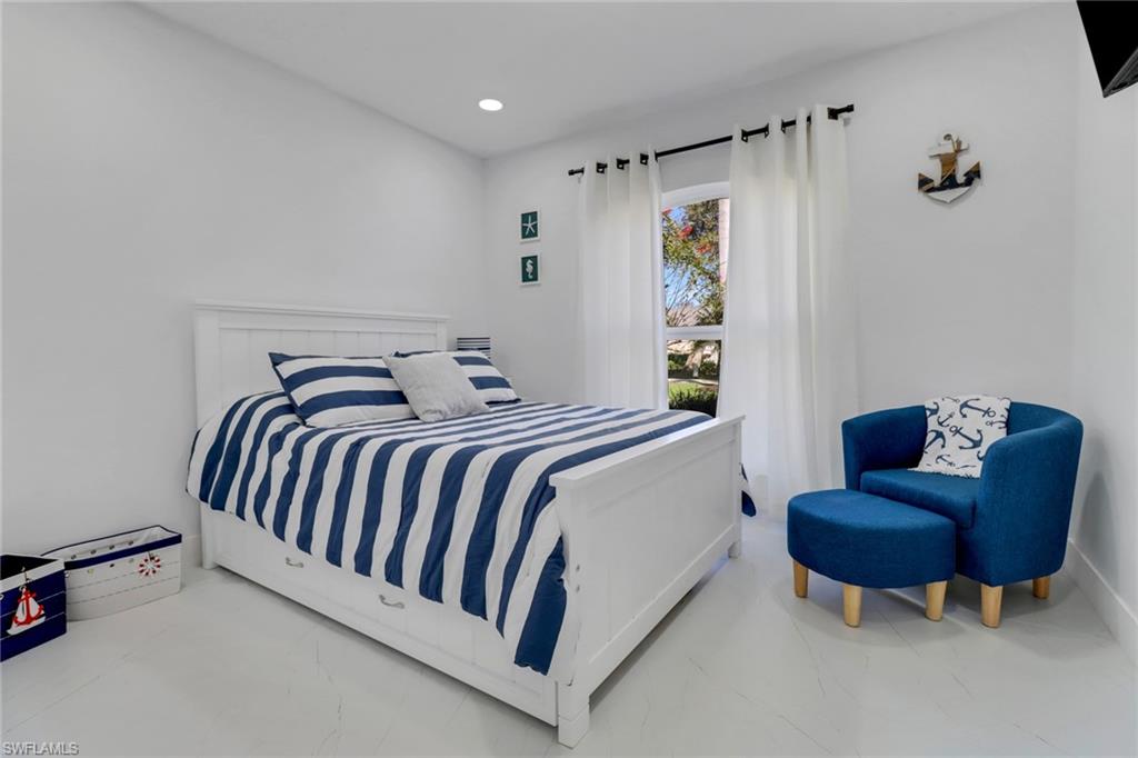 172 Plantation Circle Naples, FL 34104 - Photo 14 of 36 a bedroom with a bed and couch