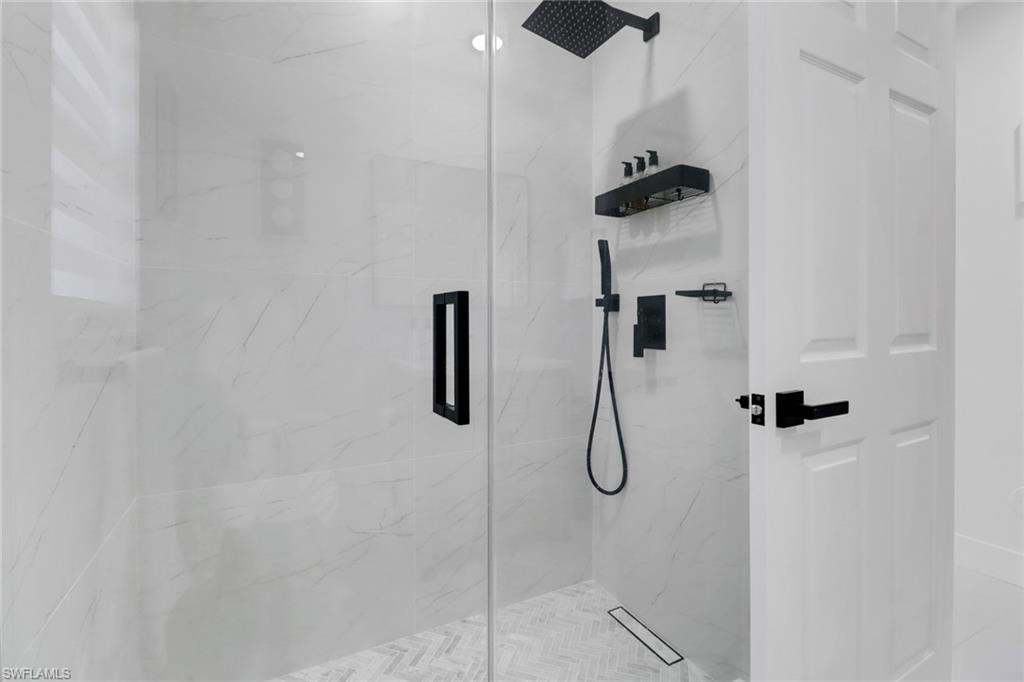 172 Plantation Circle Naples, FL 34104 - Photo 17 of 36 a bathroom with a shower