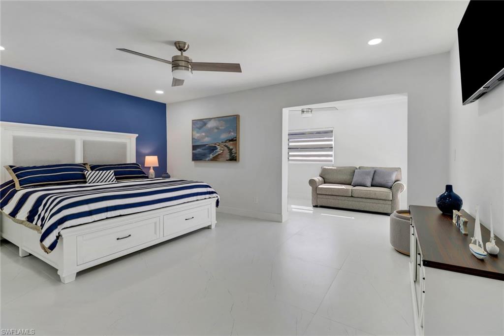 172 Plantation Circle Naples, FL 34104 - Photo 21 of 36 a bedroom with bed and a flat screen tv