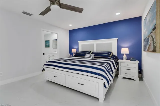 a bedroom with bed and a flat screen tv