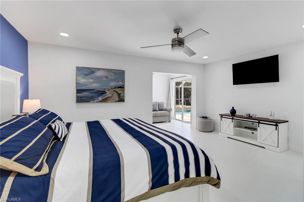 172 Plantation Circle Naples, FL 34104 - Photo 23 of 36 a bedroom with a bed and a flat screen tv