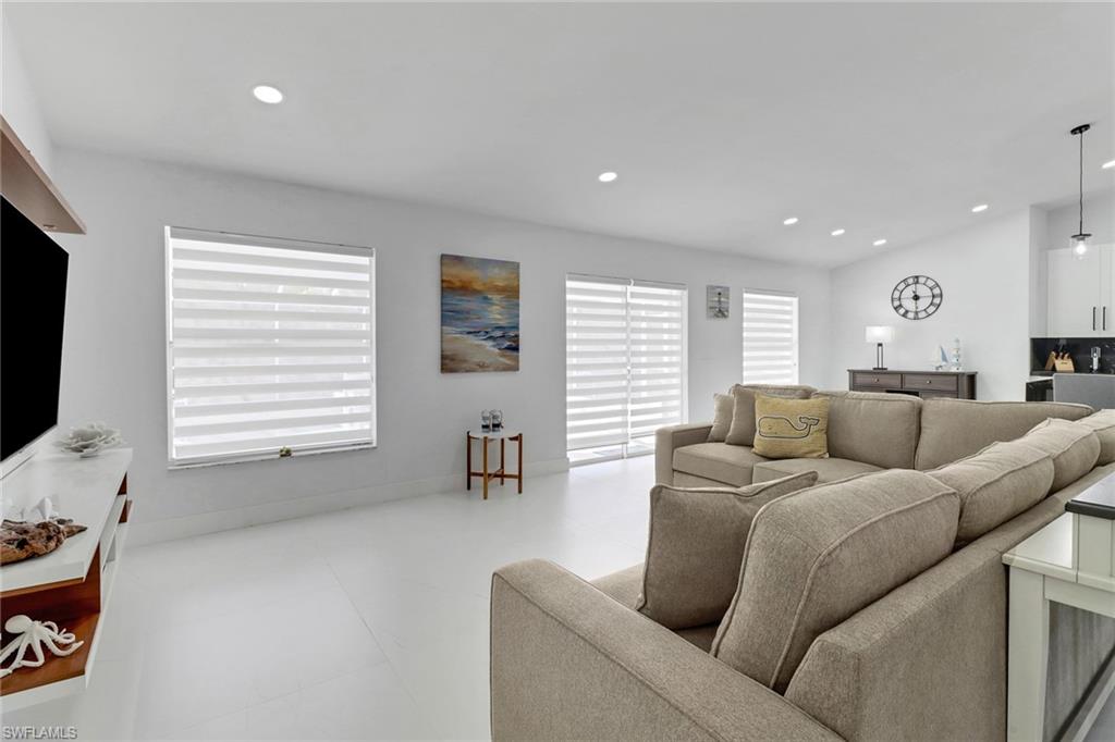 172 Plantation Circle Naples, FL 34104 - Photo 28 of 36 a living room with furniture window and a flat screen tv