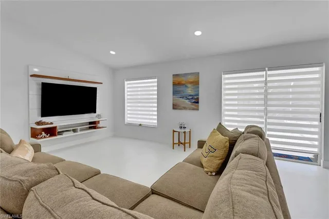 a living room with furniture window and a flat screen tv