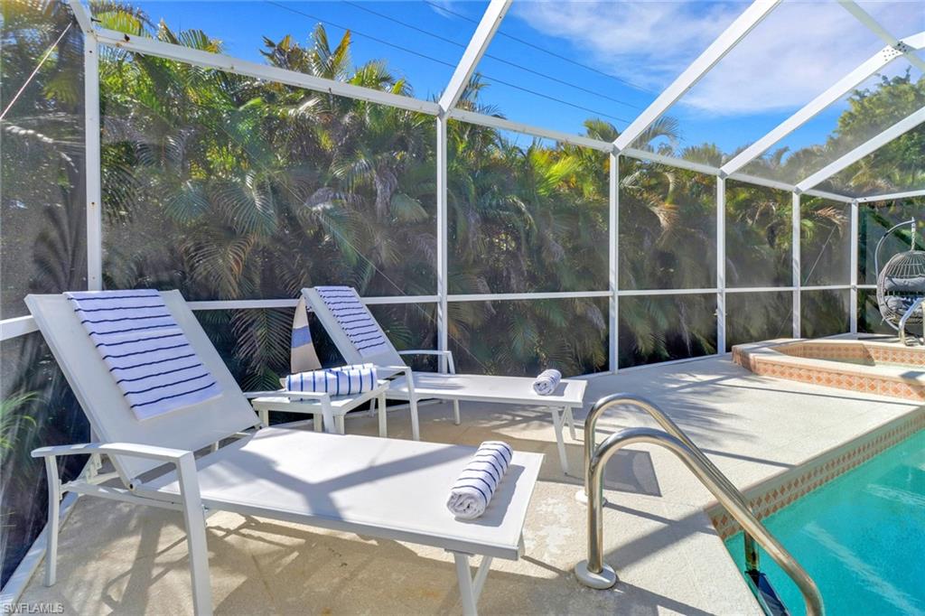 172 Plantation Circle Naples, FL 34104 - Photo 35 of 36 a view of a patio with a table chairs and wooden floor