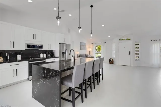 a view of a patio with a table chairs and wooden floor