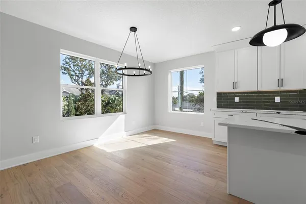 a view of a kitchen with a window and chandelier