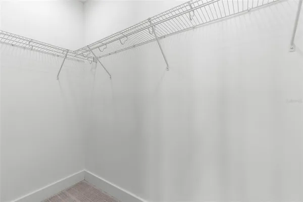 an empty room with a window and ceiling fan
