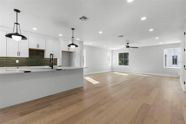a view of a kitchen with a sink and a window