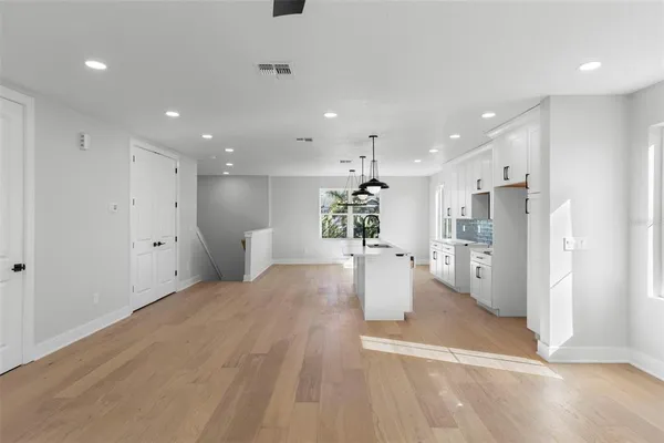 a view of a kitchen with a refrigerator and a living room
