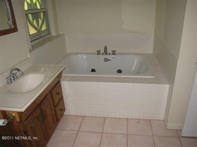 2759 Rainbow Road Jacksonville, FL 32217 - Photo 11 of 14 a bathroom with a sink a vanity and a tub