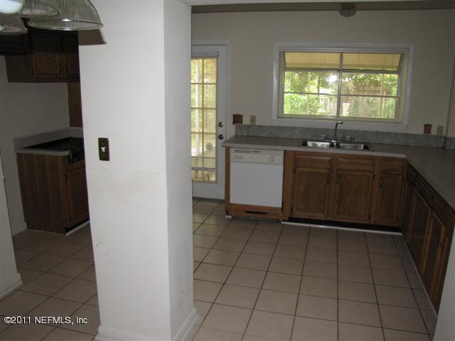 2759 Rainbow Road Jacksonville, FL 32217 - Photo 2 of 14 a kitchen with a sink a window and cabinets