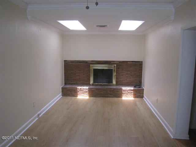 2759 Rainbow Road Jacksonville, FL 32217 - Photo 6 of 14 an empty room with windows and fireplace
