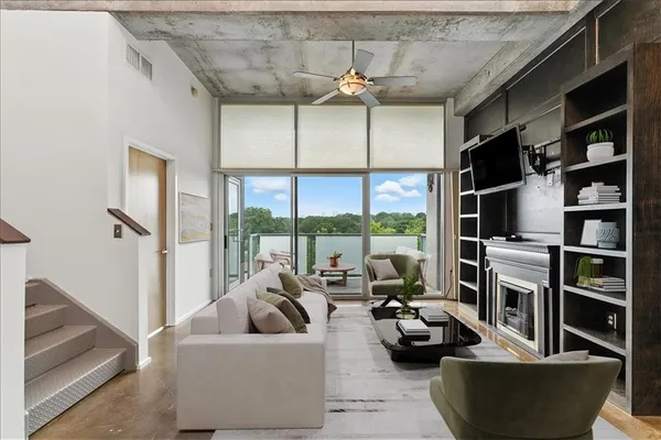 a living room with furniture and a floor to ceiling window