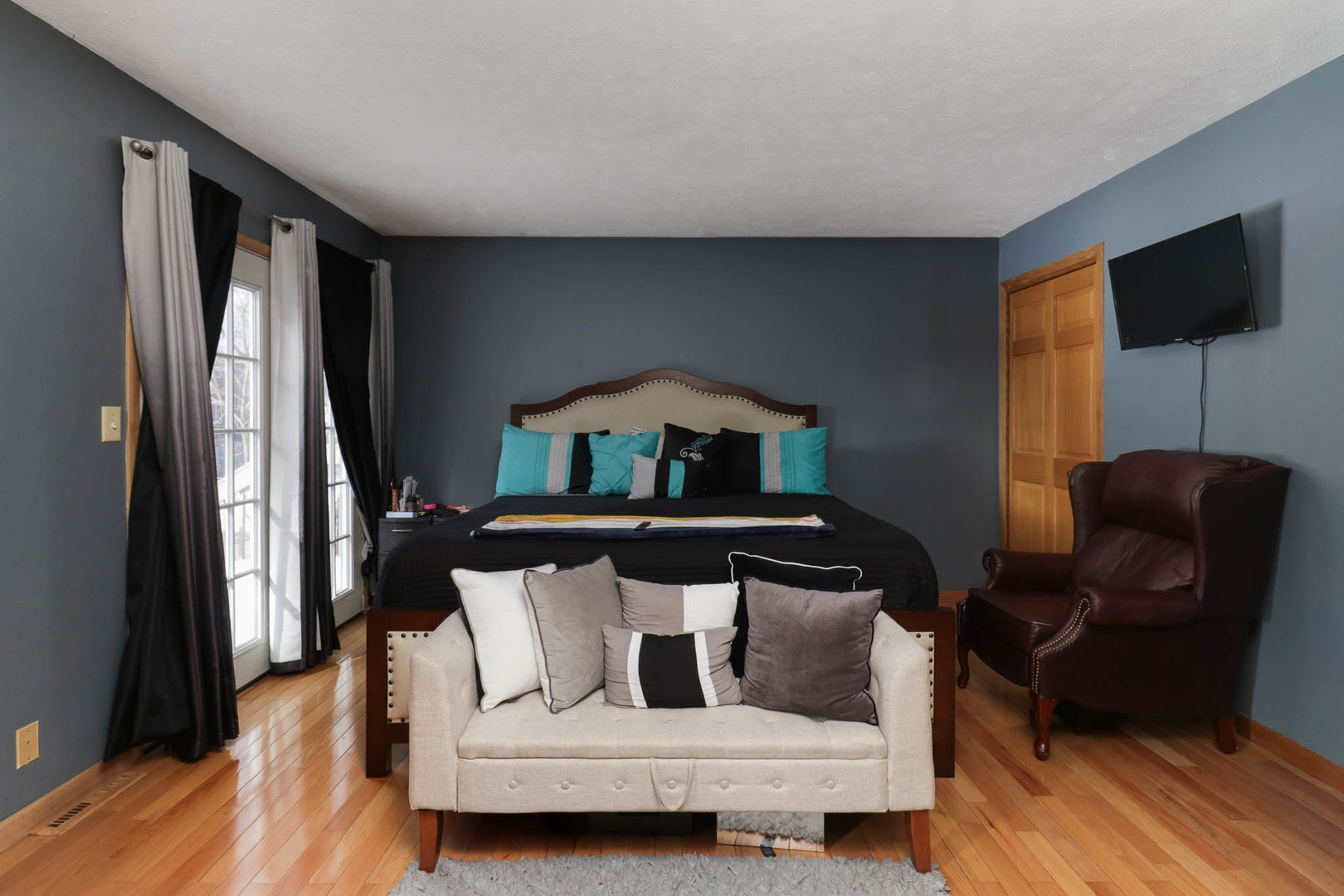 203 Edwards Drive Normal, IL 61761 - Photo 20 of 28 a bedroom with a bed a couch and a flat tv screen on a dresser