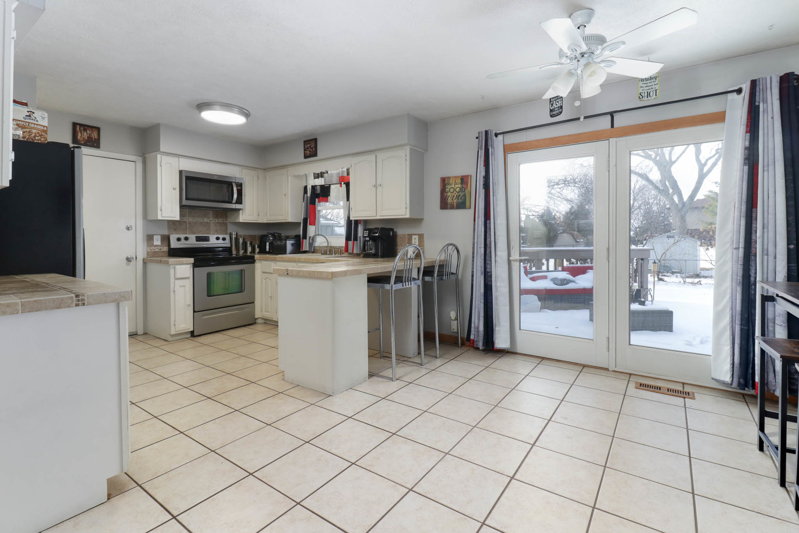 203 Edwards Drive Normal, IL 61761 - Photo 6 of 28 a kitchen with stainless steel appliances granite countertop a refrigerator oven a sink dishwasher and a stove with a dining table chair