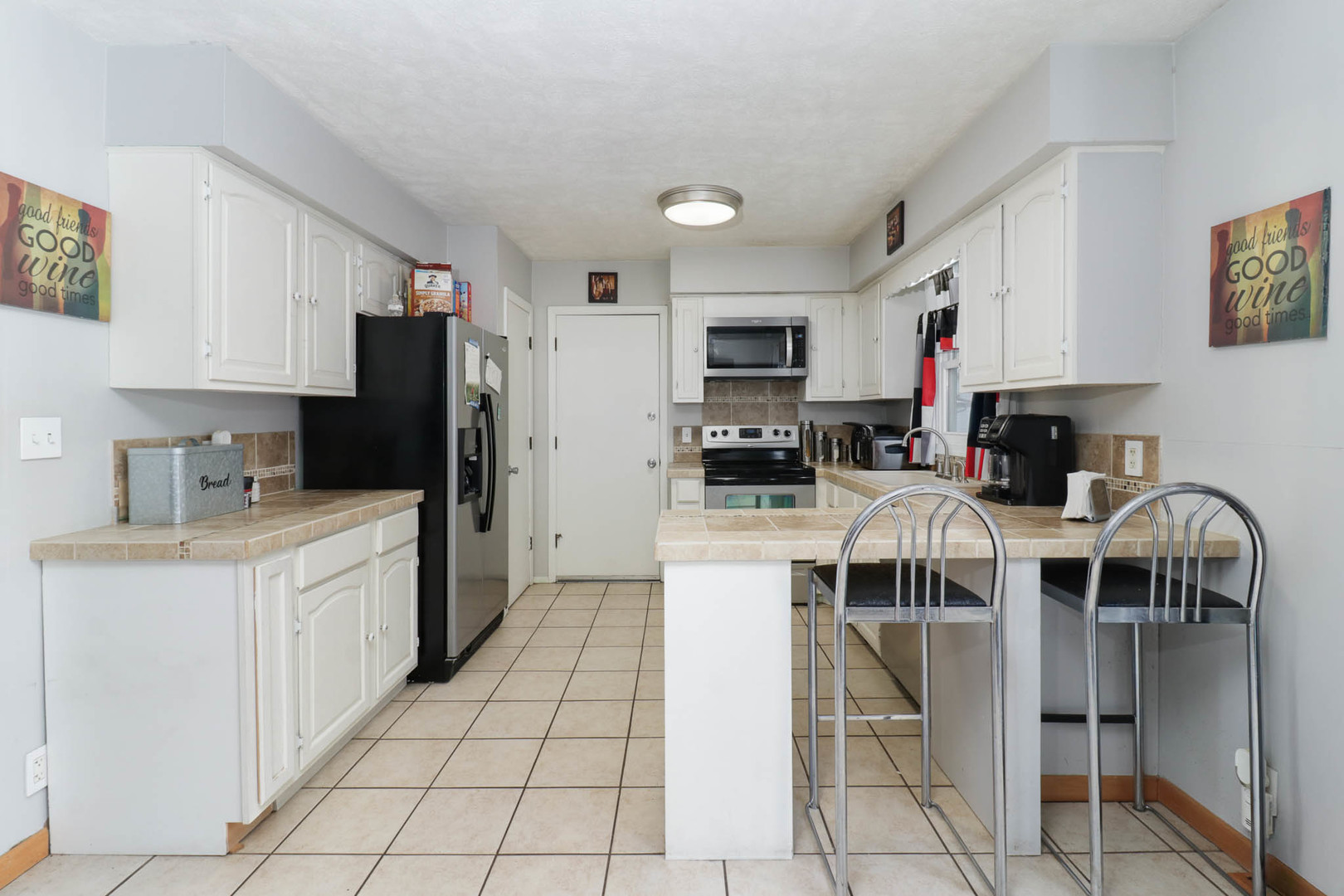 203 Edwards Drive Normal, IL 61761 - Photo 7 of 28 a kitchen with stainless steel appliances a stove a sink a microwave a refrigerator and cabinets