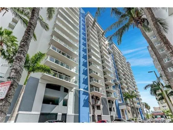 a view of a swimming pool with a table and chairs under an umbrella