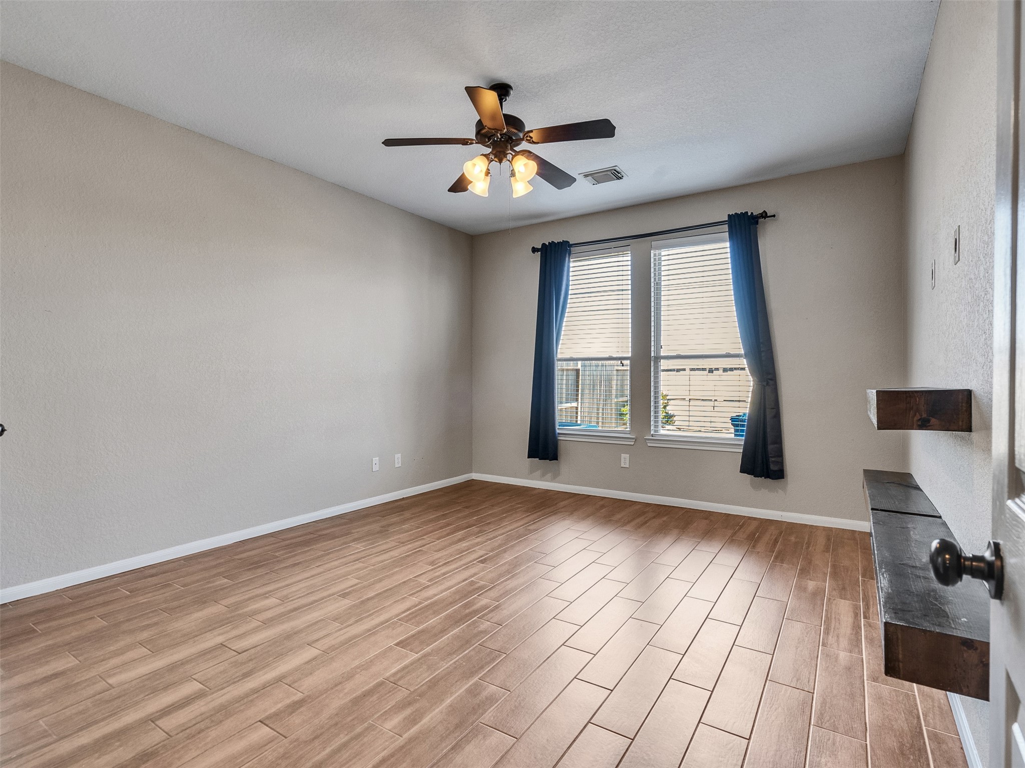 6014 Flagg Ranch Court Spring, TX 77388 - Photo 17 of 37 a view of an empty room with wooden floor and a window