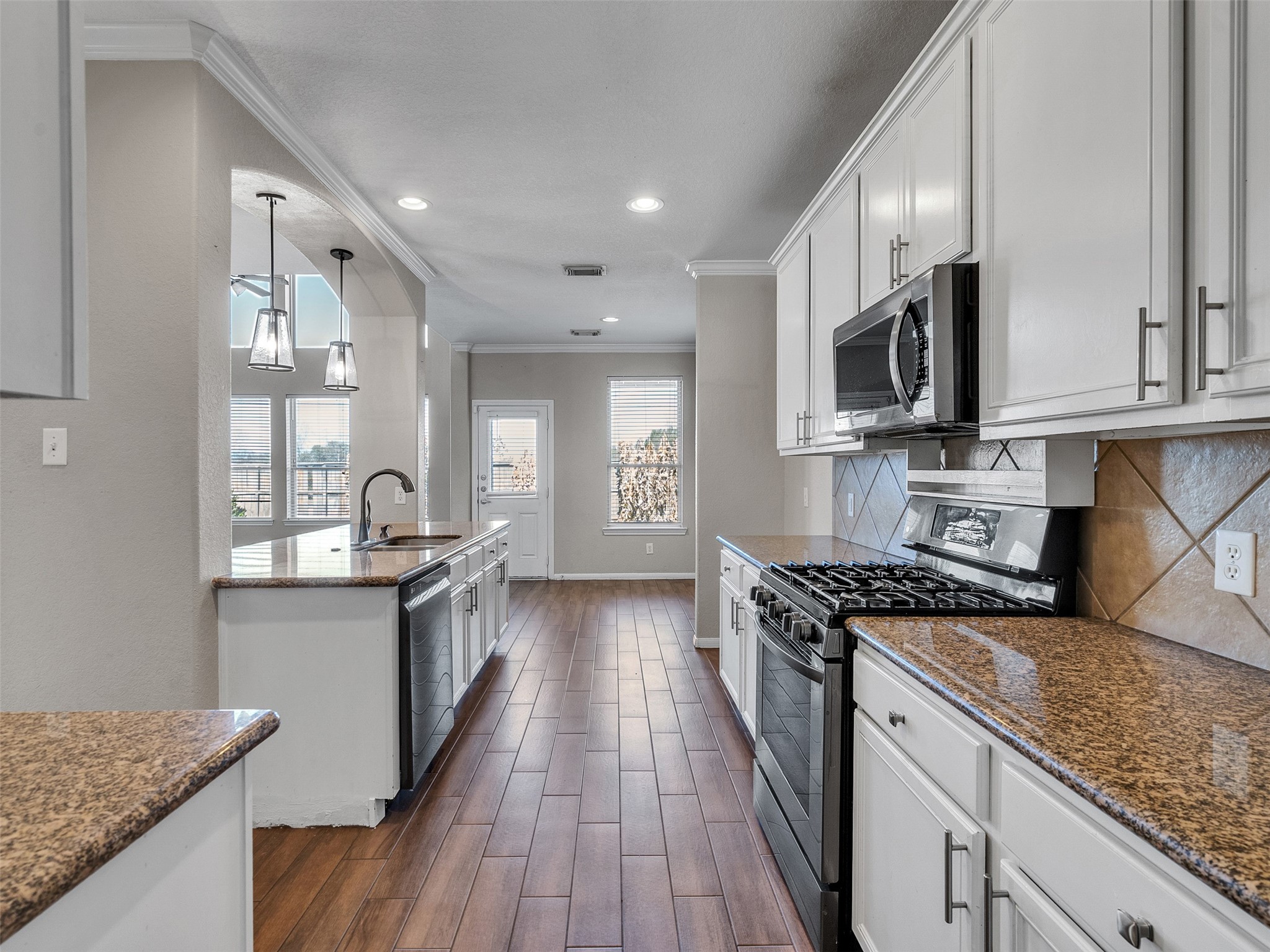6014 Flagg Ranch Court Spring, TX 77388 - Photo 8 of 37 a kitchen with stainless steel appliances granite countertop wooden cabinets and a stove top oven