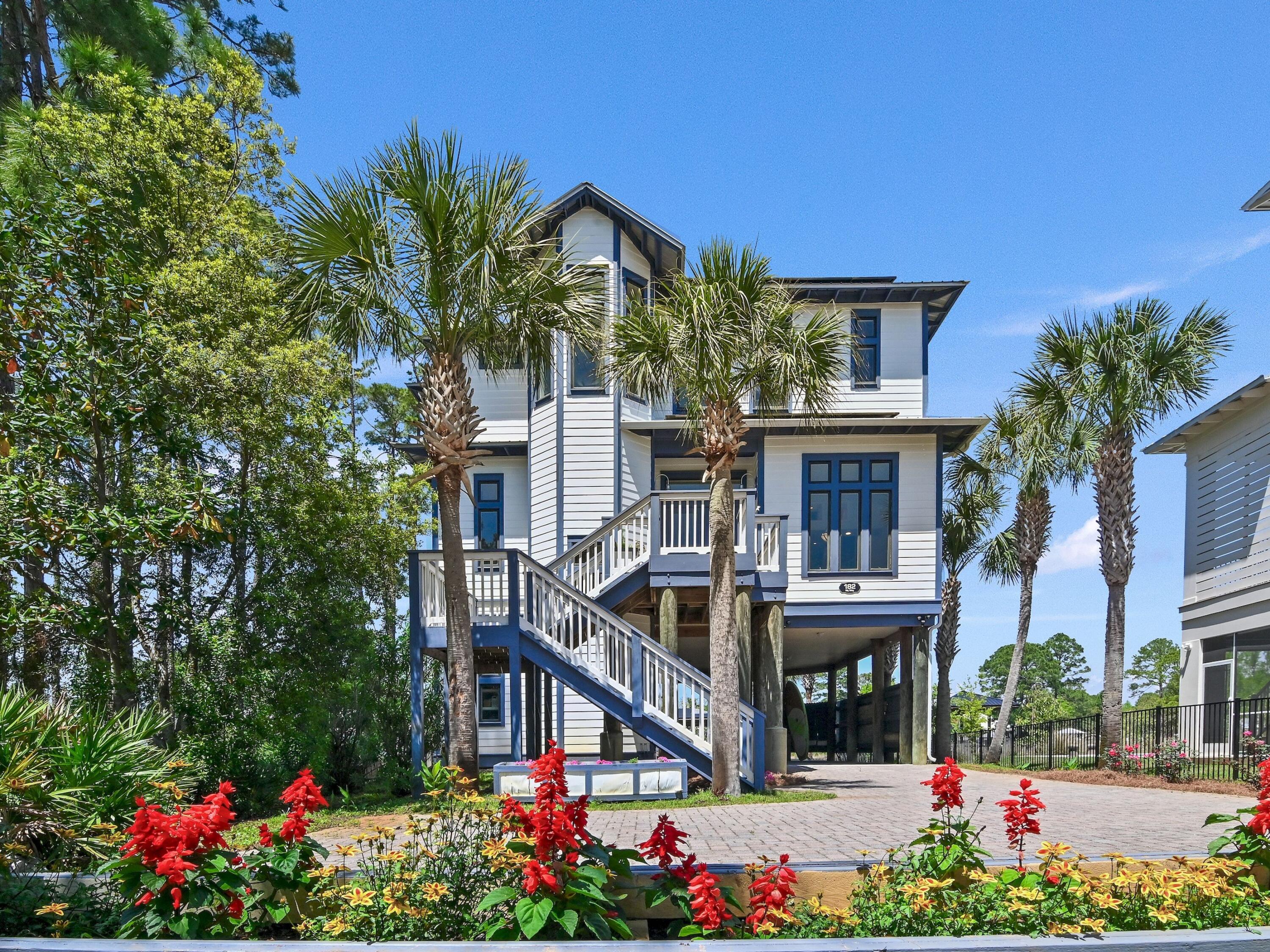 a front view of a house with a yard and fountain in middle of a house