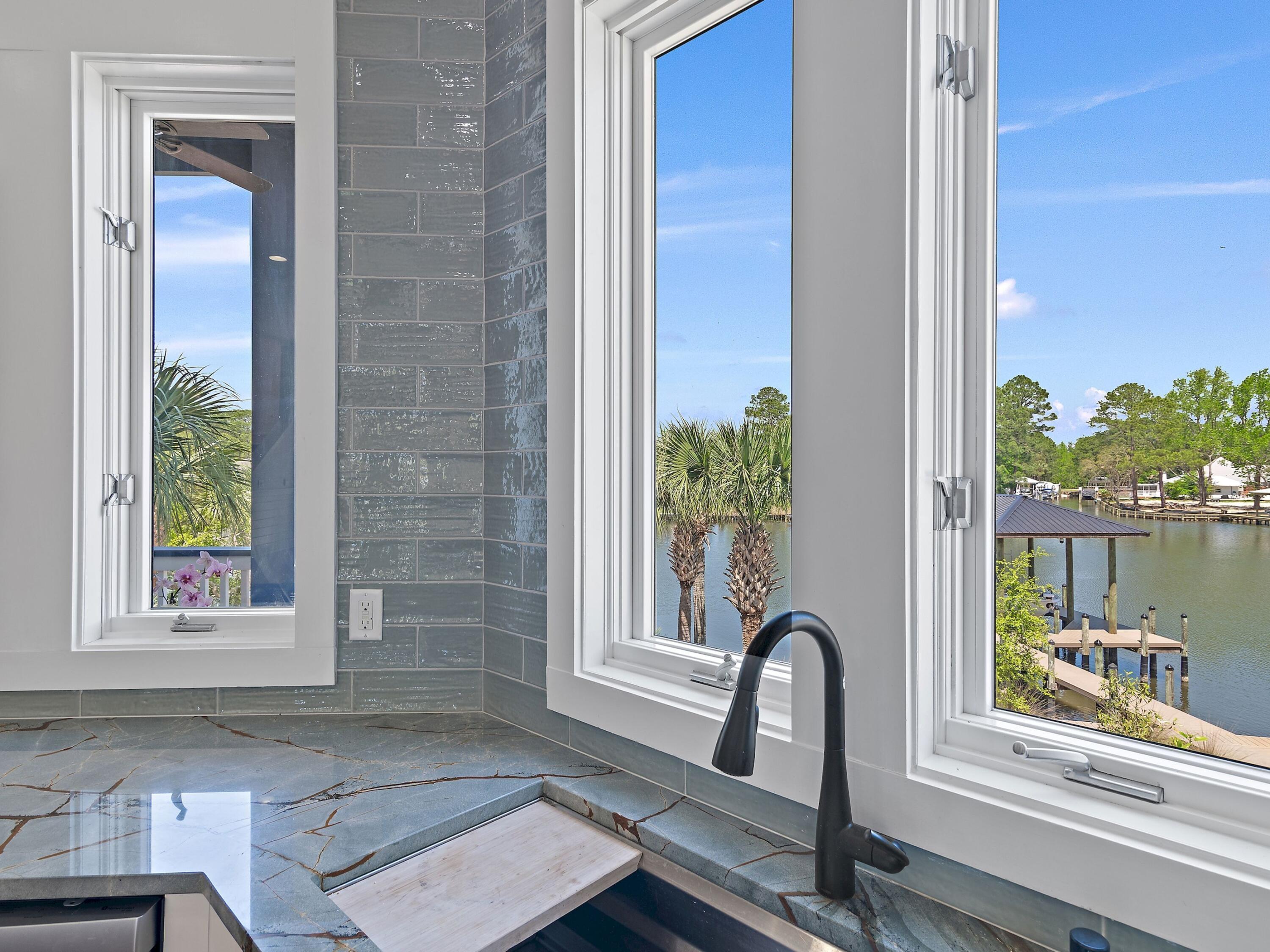 182 My Way Santa Rosa Beach, FL 32459 - Photo 12 of 39 a front view of a house with a garden