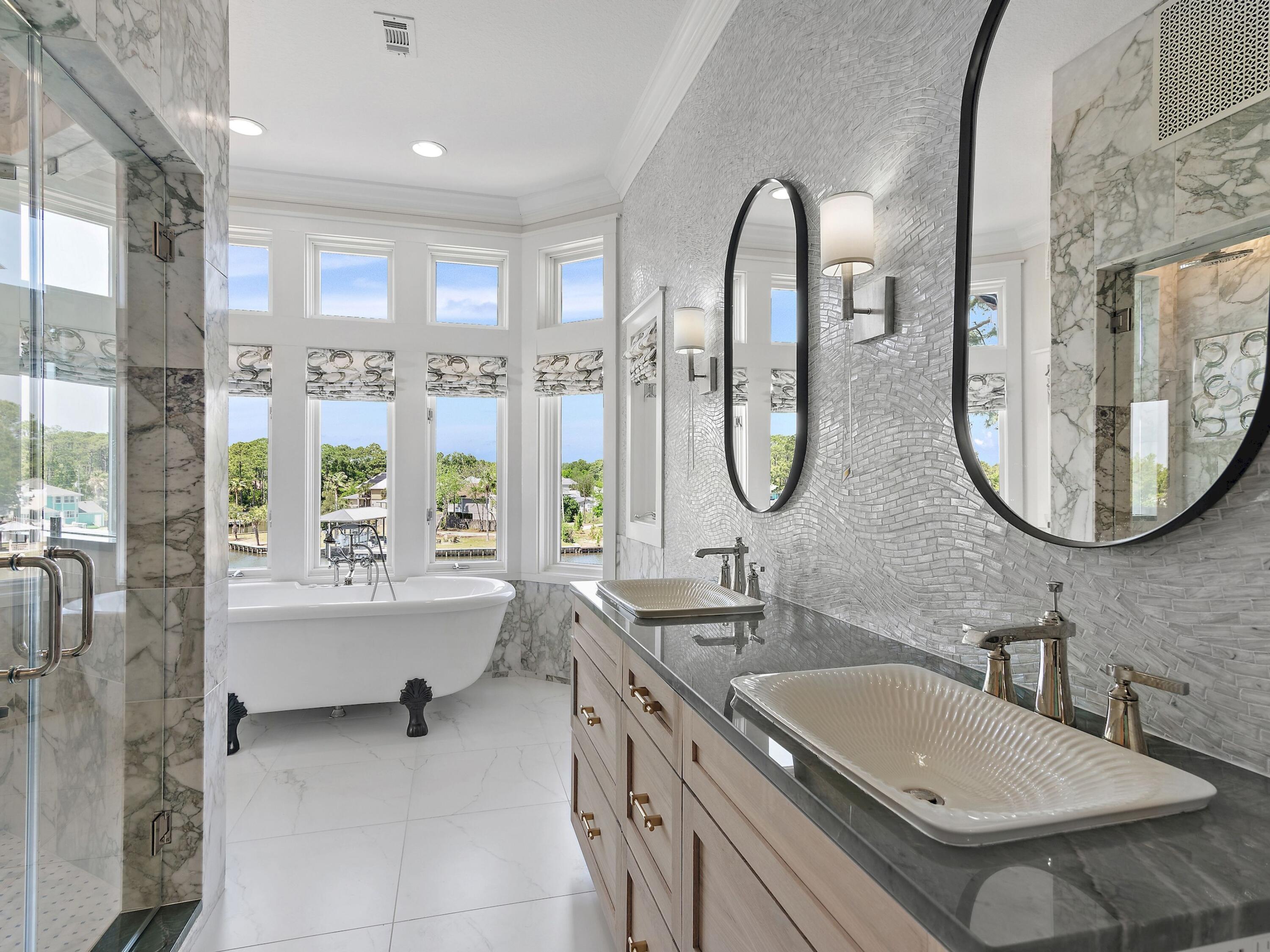 182 My Way Santa Rosa Beach, FL 32459 - Photo 21 of 39 a bathroom with a granite countertop tub a double vanity sink and a large mirror