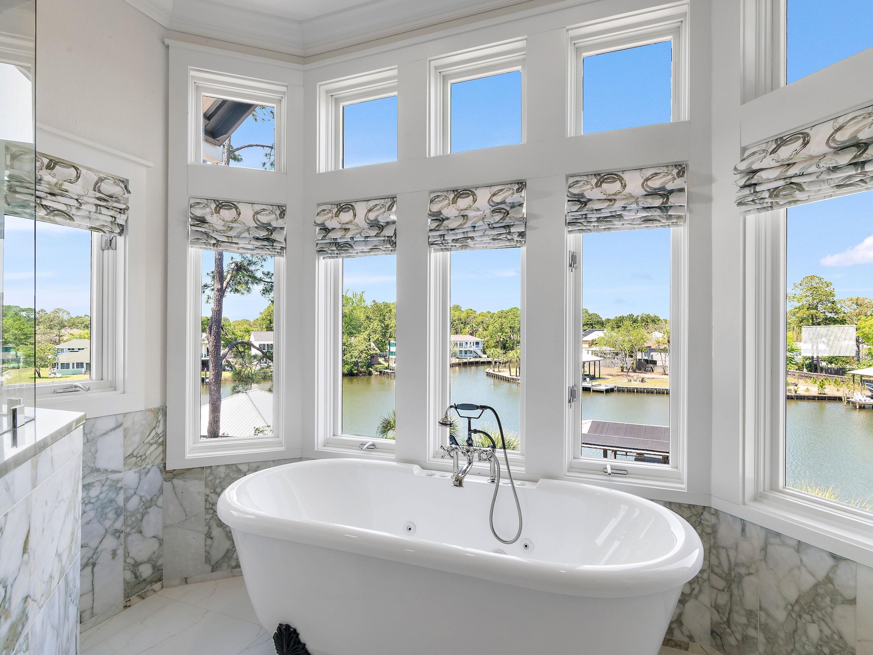 182 My Way Santa Rosa Beach, FL 32459 - Photo 22 of 39 a white bath tub sitting in front of a window