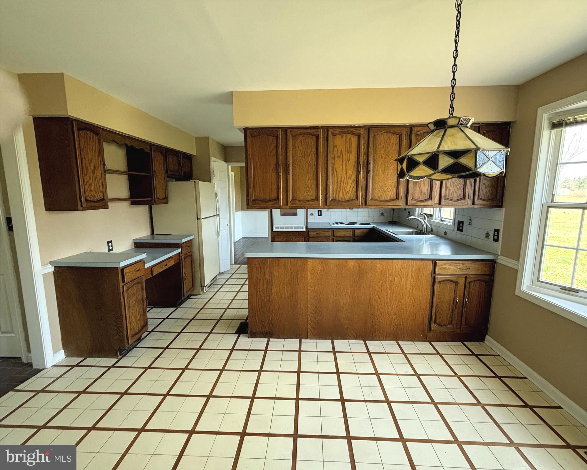 723 Godshall Road Telford, PA 18969 - Photo 11 of 31 a kitchen with a sink a counter top space cabinets and stainless steel appliances