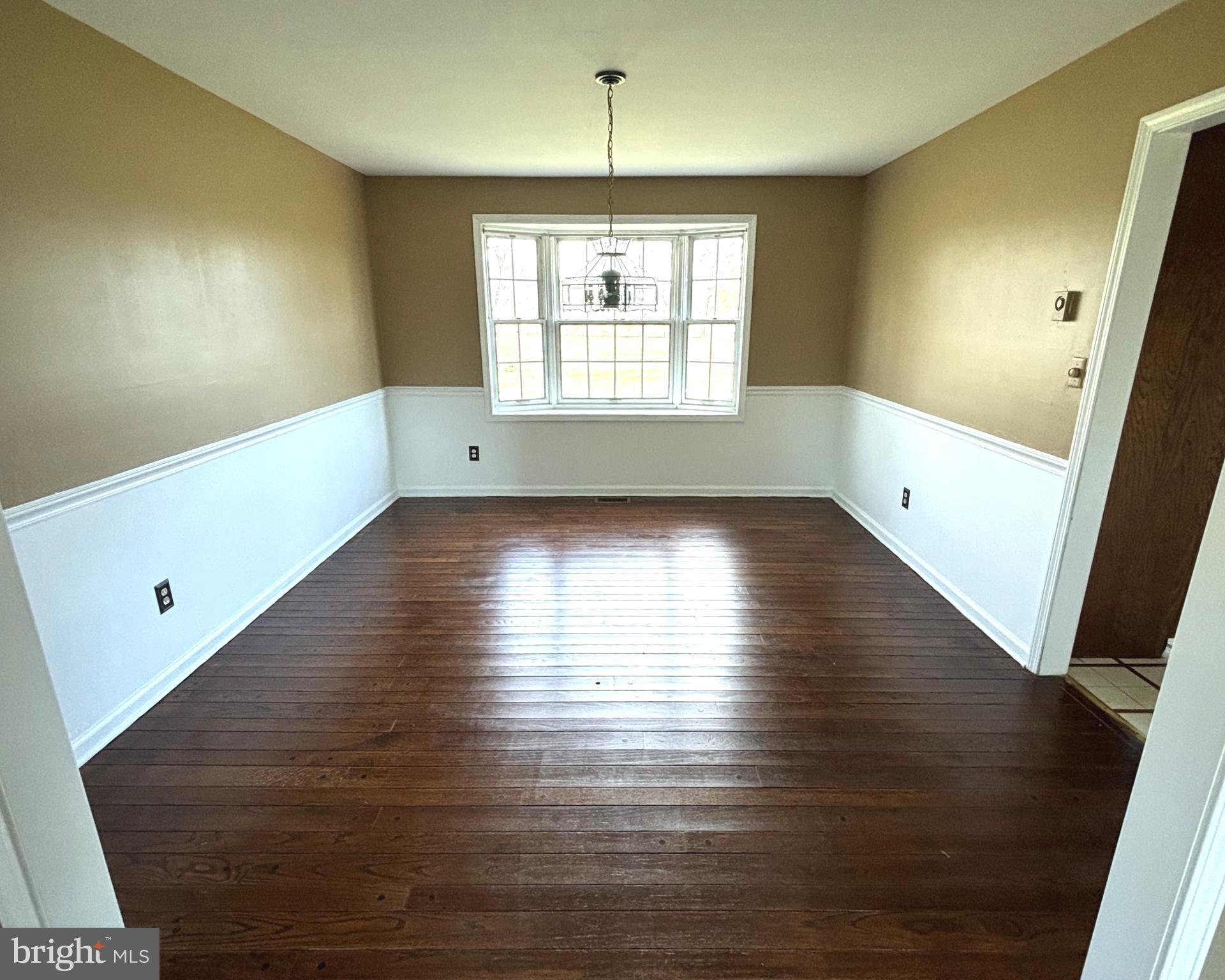 723 Godshall Road Telford, PA 18969 - Photo 9 of 31 a view of an empty room with wooden floor and a window