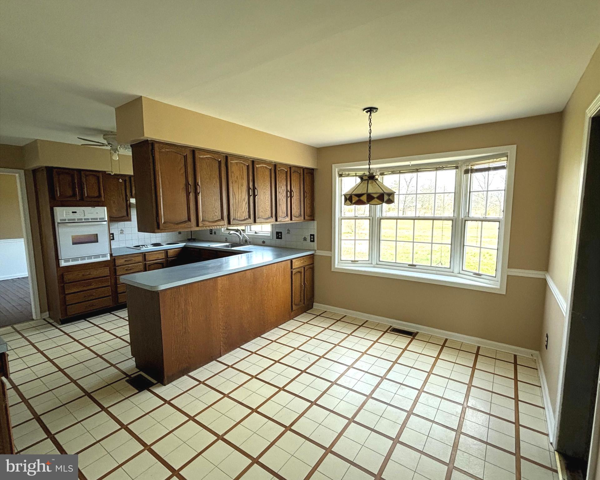 723 Godshall Road Telford, PA 18969 - Photo 10 of 31 a kitchen with stainless steel appliances granite countertop a stove a sink and a microwave