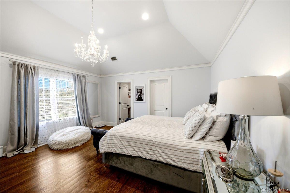 7 Ridgeview Circle Armonk, NY 10504 - Photo 29 of 50 a bedroom with a bed and a chandelier