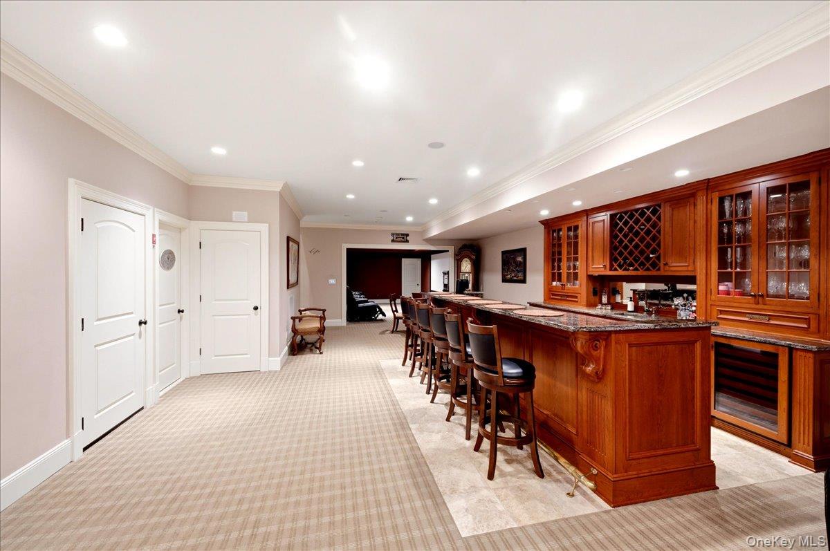 7 Ridgeview Circle Armonk, NY 10504 - Photo 34 of 50 a kitchen with stainless steel appliances kitchen island granite countertop a refrigerator a sink a stove a dining table and chairs