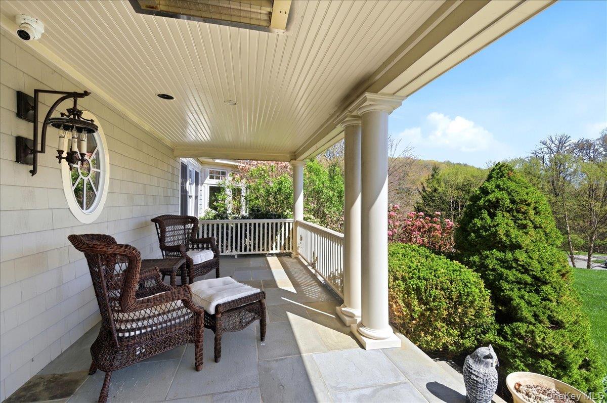 7 Ridgeview Circle Armonk, NY 10504 - Photo 4 of 50 a balcony with chairs and a table