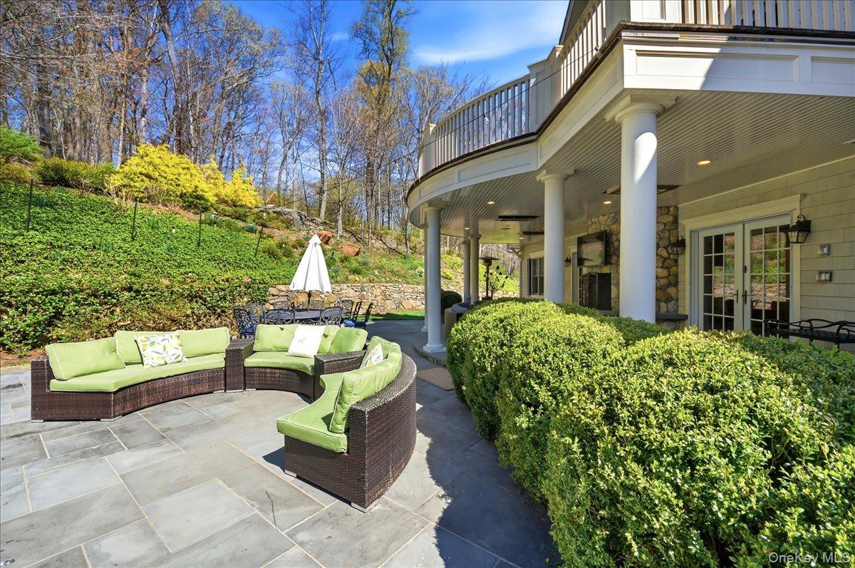 7 Ridgeview Circle Armonk, NY 10504 - Photo 42 of 50 a view of a patio with couches table and chairs with potted plants