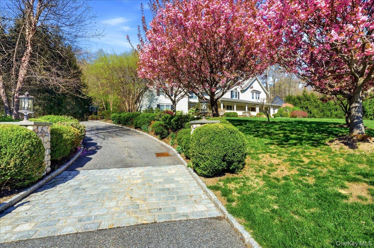 7 Ridgeview Circle Armonk, NY 10504 - Photo 45 of 50 a front view of a house with a yard and shrubs