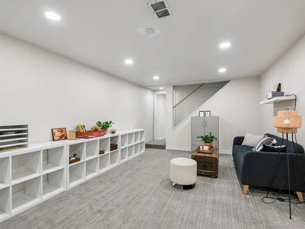 a bedroom with a large bed and a refrigerator