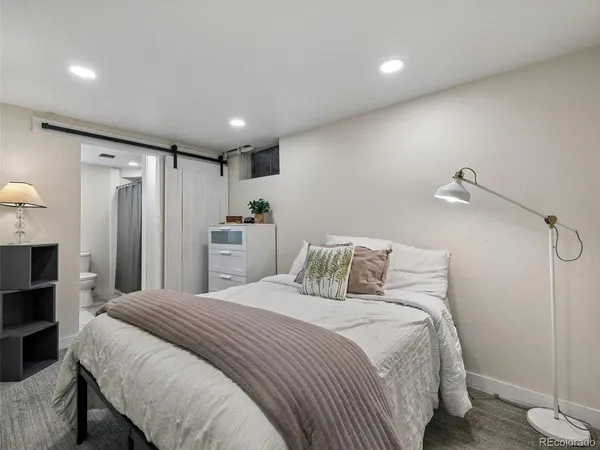 a bedroom with a bed and a potted plant