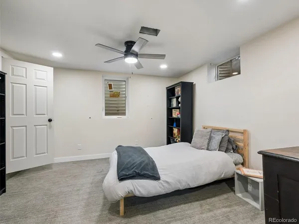 a bedroom with furniture and a book shelf