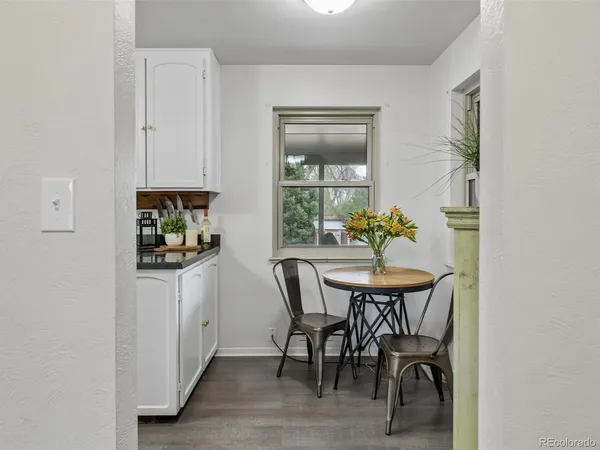 a kitchen with granite countertop white cabinets white stainless steel appliances and sink