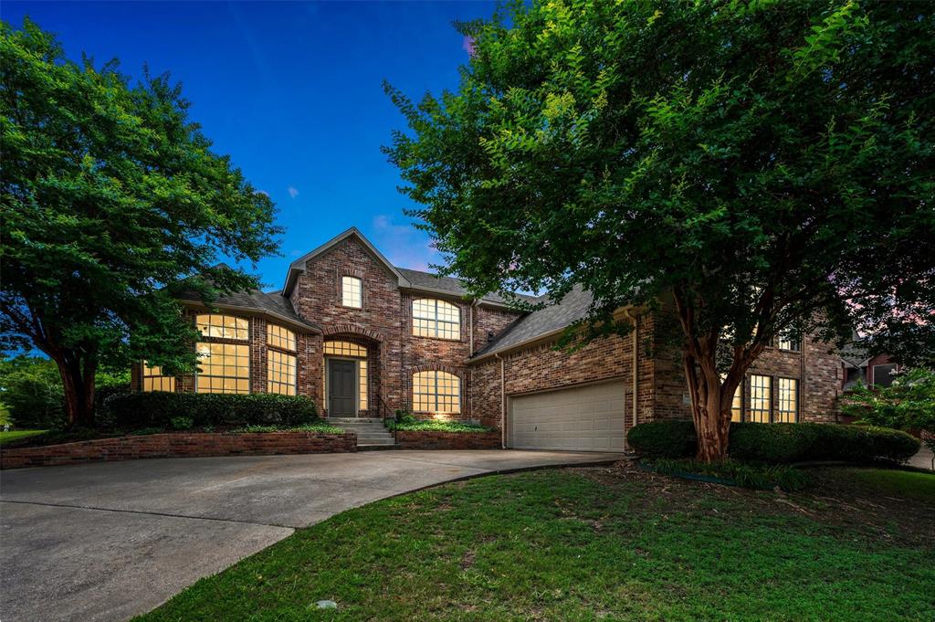 Brick exterior featuring multiple arched windows and a prominent front entry