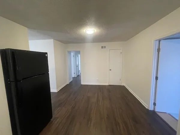 a view of a refrigerator in wooden floor
